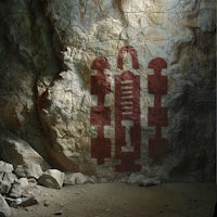 an image of a cave with a painting on it